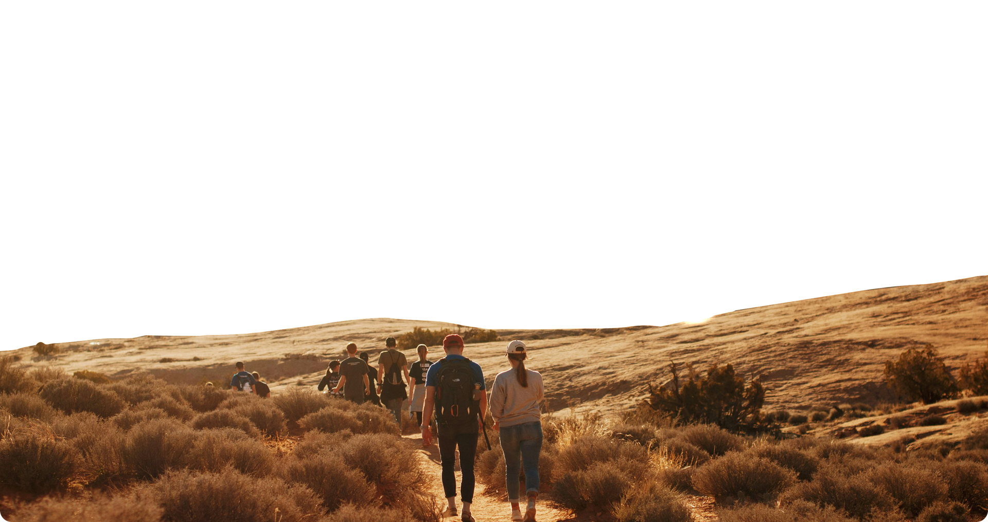 people walking along a path in the desert.